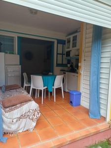 a patio with a table and chairs on a house at Our dream in blue in Sèze