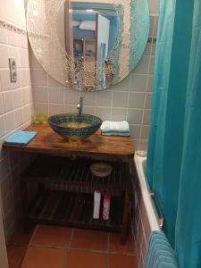 a bathroom with a sink and a mirror at Our dream in blue in Sèze +31 photos