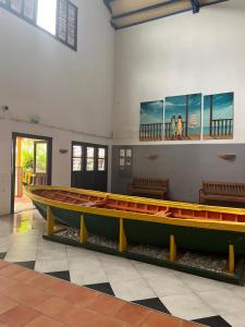 a large boat on display in a room with benches at Our dream in blue in Sèze