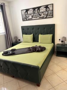 a bed with a black headboard in a bedroom at Rosa dei venti 3 in Santa Maria