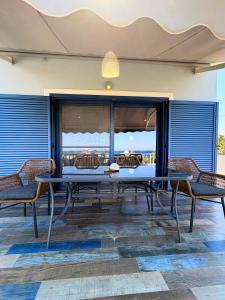 a table and chairs on a patio with a view at The Dona House in Vaia +15 photos