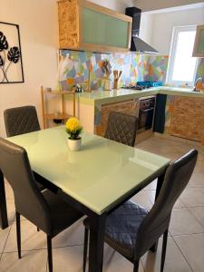 a kitchen with a table and chairs in a kitchen at Rosa dei venti 3 in Santa Maria +7 photos