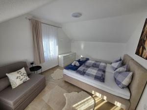 a bedroom with a bed and a couch at Velebitska Vila in Gračac