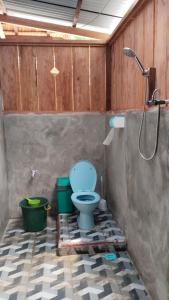 a bathroom with a blue toilet and a shower at Frits Homestay in Kri +51 photos