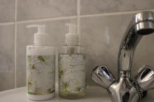 two bottles of soap sitting on top of a sink at Thami residence - Self catering in Grahamstown