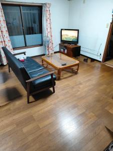 a living room with a couch and a coffee table at 海っぺり宮崎 in Miyazaki