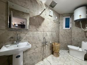 a bathroom with a sink and a toilet at FarahBakshResidency in Srinagar