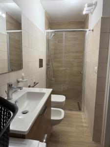a bathroom with a shower and a sink and a toilet at Casa Vacanze Nicol in Licata