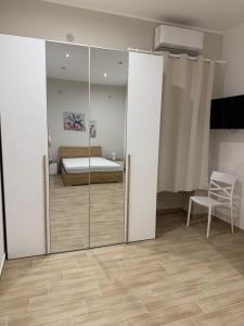 a bedroom with a bed and a sliding glass door at Casa Vacanze Nicol in Licata