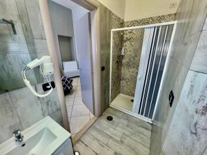 a bathroom with a shower and a sink at Tuanis in Naples +59 photos