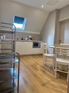 a living room with a bunk bed and a kitchen at Villa du Parc de Scey in Dole
