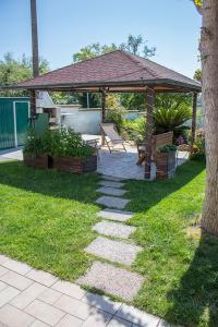 a garden with a gazebo and a bench at GinKgo B&B in Francavilla al Mare