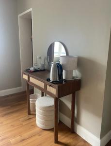 a wooden dressing table with a mirror and a sink at Glasha Meadows Accommodation in Doolin +36 photos