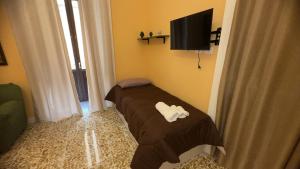 a room with two beds and a flat screen tv at B&B Giardino Incantato in Piazza Armerina