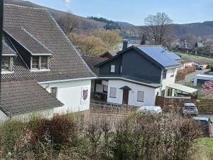 a house with solar panels on its roof at Ferienwohnung Buchenblatt in Simmerath