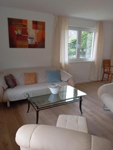 a living room with a couch and a coffee table at Ferienwohnung Buchenblatt in Simmerath