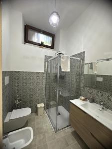 a bathroom with a shower and a toilet and a sink at B&B Giardino Incantato in Piazza Armerina +74 photos