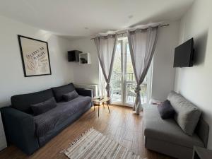 a living room with a couch and a window at ApartmentsByMatyrafa-XV in Tarnowskie Góry