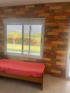 a room with a red bench and a window at Cina Cina, casita in Zonda +23 photos
