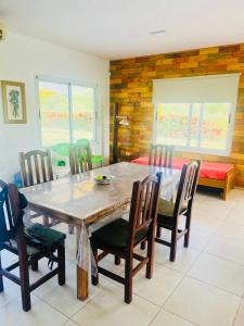 a dining room with a wooden table and chairs at Cina Cina, casita in Zonda