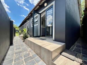 a house with glass doors on the side of it at No 6 On Cladon # Jadde Apartments in Chartwell