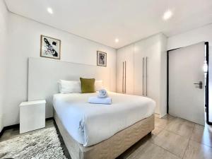 a bedroom with a large white bed in a room at No 6 On Cladon # Jadde Apartments in Chartwell