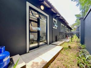 a house with a glass door and a porch at No 6 On Cladon # Jadde Apartments in Chartwell +1 photo