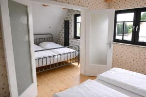 a room with two beds and an open door at Ferienhaus in Graal-Müritz in Graal-Müritz +8 photos
