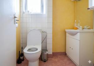 a bathroom with a white toilet and a sink at Au Bon Pasteur RDC proche des voies routières et du centre ville in Cholet +25 photos