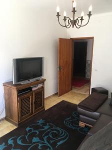 a living room with a tv and a couch at Lovely grandma house in Vila Viçosa