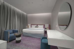a hotel room with a bed and a mirror at Marvelous Hotel in Tabuk +18 photos