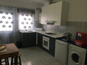 a kitchen with a stove top oven next to a window at Lovely grandma house in Vila Viçosa