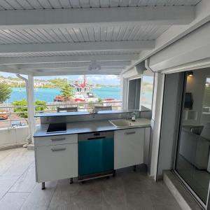 a kitchen with a sink and a view of the water at Le Loft in Pointe-à-Pitre