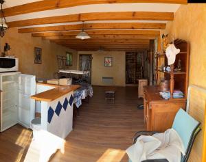 a large kitchen with wooden floors and a counter top at La grange un refuge in Mijanès