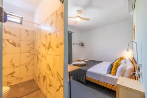 a room with a bed and a bathroom with a shower at Casa de Océano in Tarifa +91 photos