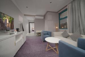 a living room with a couch and a table at Marvelous Hotel in Tabuk