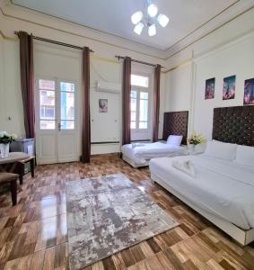 a bedroom with two beds and a couch and a table at Dawn town palace in Cairo