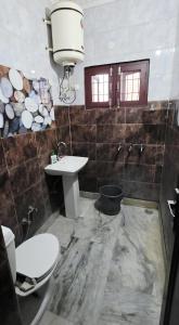 a bathroom with a toilet and a sink at StayStudio in Jammu