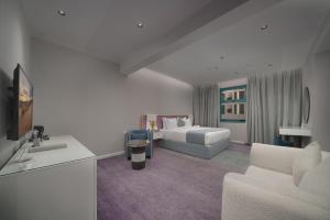 a hotel room with a bed and a living room at Marvelous Hotel in Tabuk