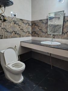 a bathroom with a toilet and a sink at Hotel king palace family stay in Agra