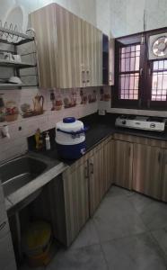 a kitchen with a sink and a clock on the wall at StayStudio in Jammu