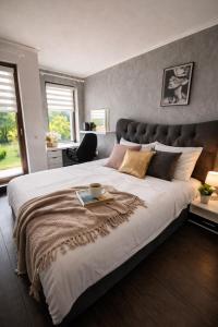 a bedroom with a large bed with a tray on it at Marica Apartment in Plovdiv
