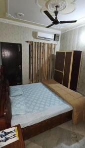 a bedroom with a large bed with a ceiling at StayStudio in Jammu