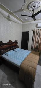 a bedroom with a bed and a ceiling at StayStudio in Jammu