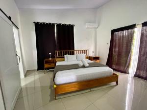 a bedroom with a bed and a large window at Arenal Views, Pool & 5min to Waterfall & Town in Fortuna +39 photos