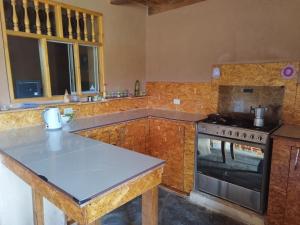 a kitchen with a stove and a counter top at GAIA kuelap in Nuevo Tingo