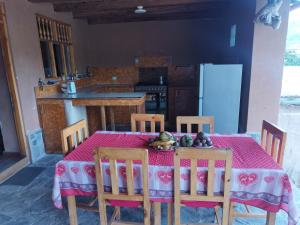 a kitchen with a table with a red table cloth at GAIA kuelap in Nuevo Tingo +38 photos