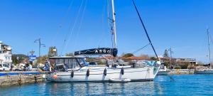 a white sailboat is docked in the water at ARGO III Sailing Yacht in Skiathos