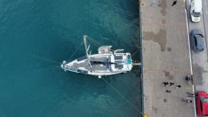 a boat tied to a dock in the water at ARGO III Sailing Yacht in Skiathos +1 photo