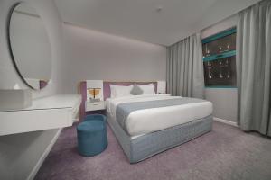 a rendering of a bedroom with a bed and a mirror at Marvelous Hotel in Tabuk